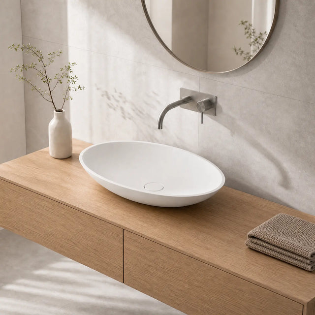Bathroom vanity with a white sink, wooden cabinet, and decorative elements.