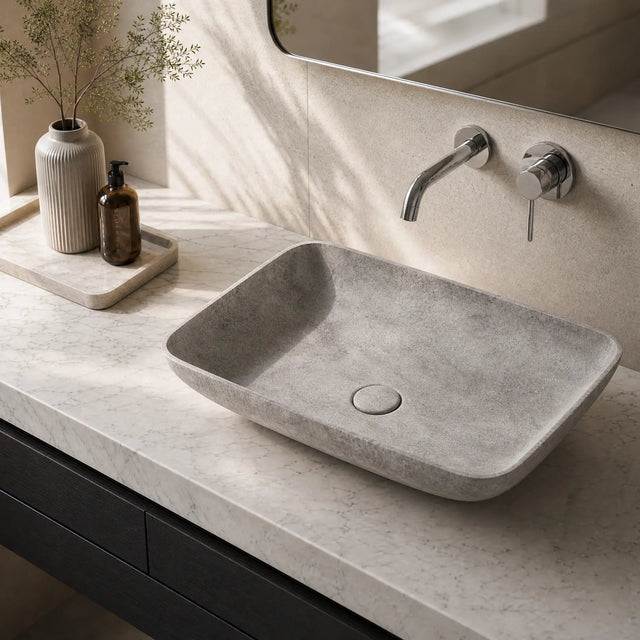 Bathroom vanity with a concrete sink and faucet