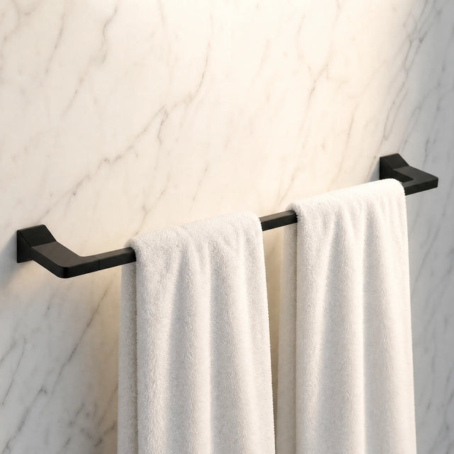 Black towel rack with white towels on a marble wall