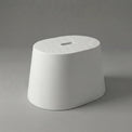 White textured stool on a gray background