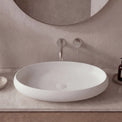 Modern bathroom sink with faucet and mirror on a neutral wall.