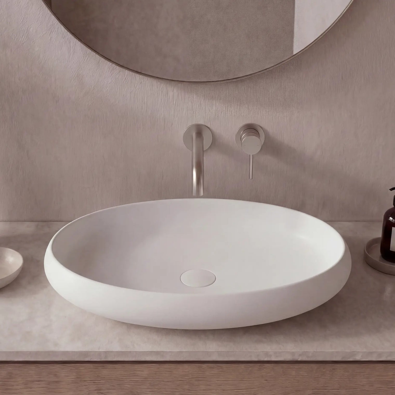 Modern bathroom sink with faucet and mirror on a neutral wall.