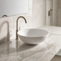 Bathroom sink with marble countertop and tiled wall
