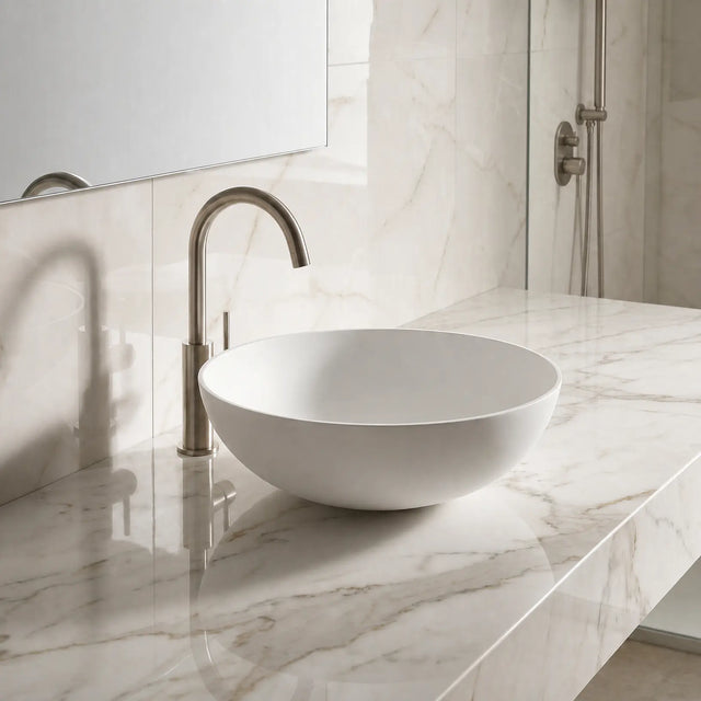 Bathroom sink with marble countertop and tiled wall