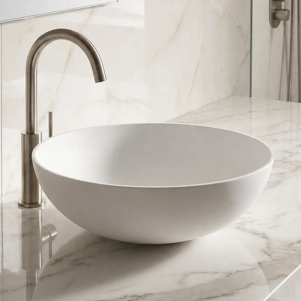 Bathroom sink with marble countertop and tiled wall