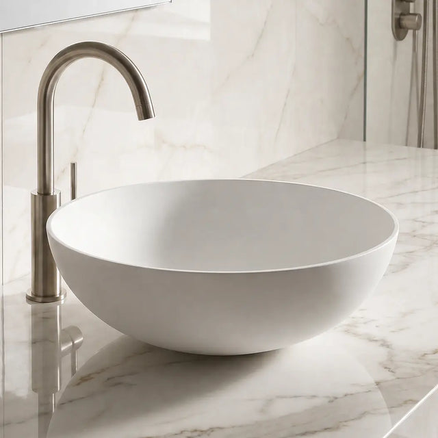 Bathroom sink with marble countertop and tiled wall