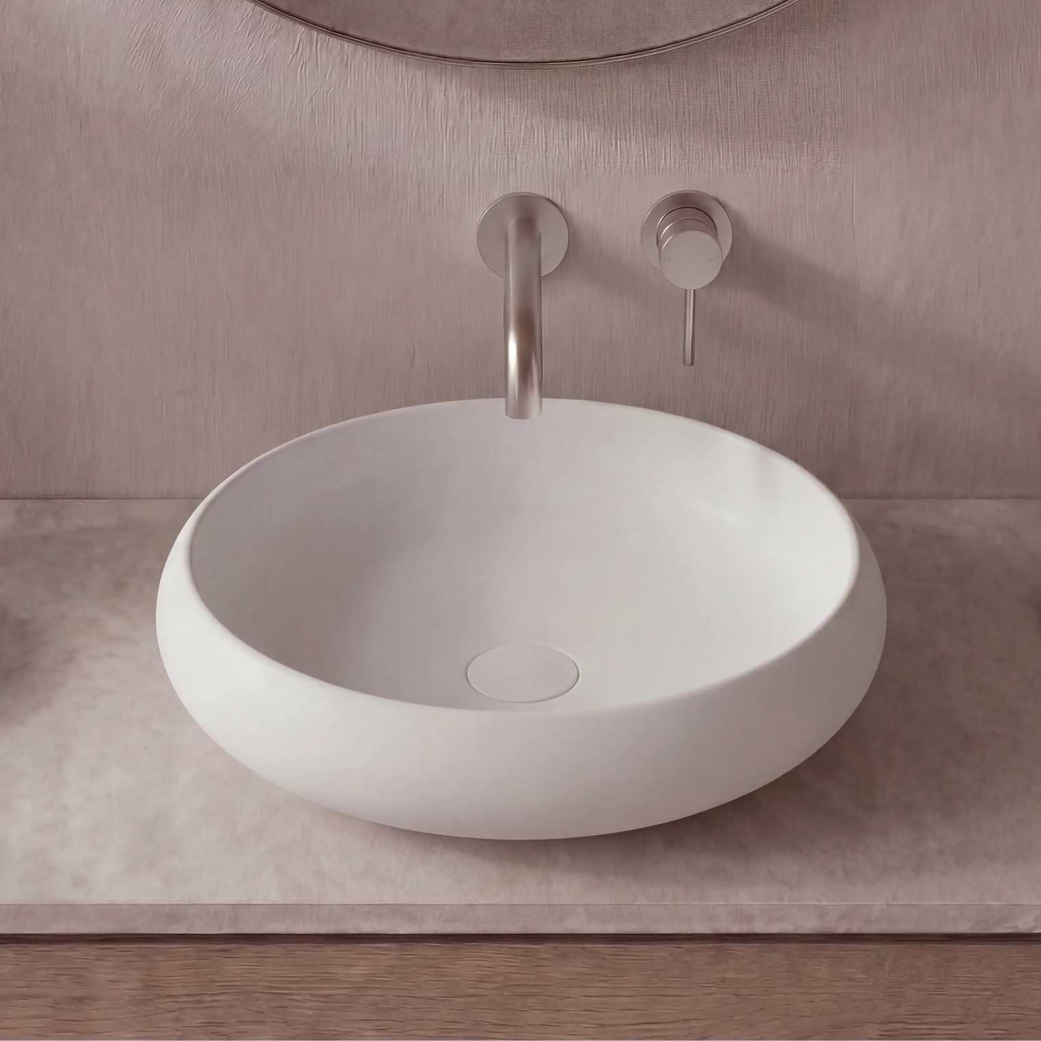 Modern bathroom vanity with a white sink, faucet, and decorative items.