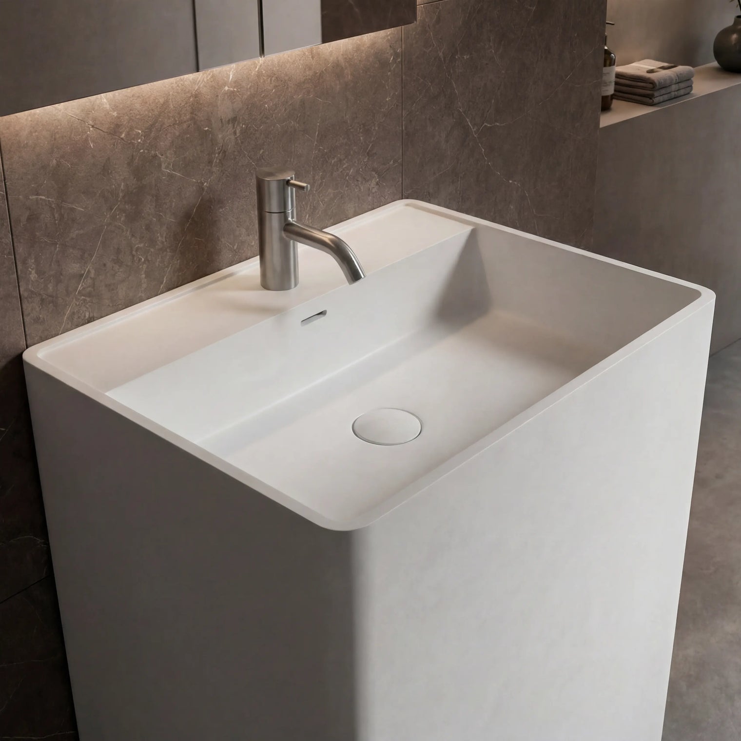 Modern bathroom sink with faucet against a tiled wall