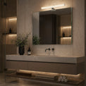 Modern bathroom with a vanity, mirror, and decorative elements.