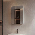 Modern bathroom with a sink, mirror, and shower area.