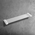 bathroom accessory NUUK Shower Shelf 50 with zinc base and brass pipe mounted on gray wall